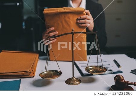 Judge gavel with Justice lawyers having team meeting at law firm background. Concepts of Law and Legal services. 124221060