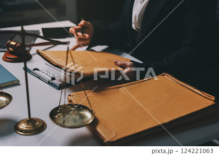 Judge gavel with Justice lawyers having team meeting at law firm background. Concepts of Law and Legal services. 124221063
