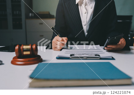 Judge gavel with Justice lawyers having team meeting at law firm background. Concepts of Law and Legal services. 124221074