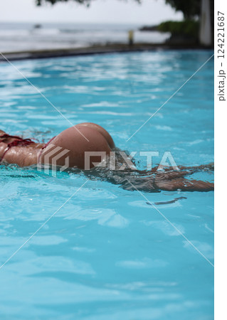Enjoying the Art of Graceful Swimming in the Crystal Clear Pool Water during Summer Days Enjoying the Art of Graceful Swimming in the Crystal Clear Pool Water during Summer Days 124221687
