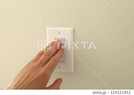 hand pressing wall light switch hand pressing wall light switch 124221951