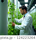 businessman using tablet at dusk with industrial backdrop, concept of technology in industry, environmental monitoring 124223264