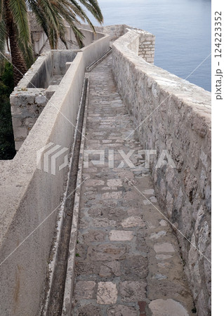 Defense walls of the old town of Dubrovnik, a well-preserved medieval fortress and a popular tourist destination, Croatia Defense walls of the old town of Dubrovnik, a well-preserved medieval fortress and a popular tourist destination, Croatia 124223352