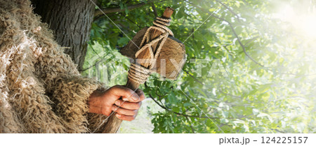 Old hand with stone axe 124225157