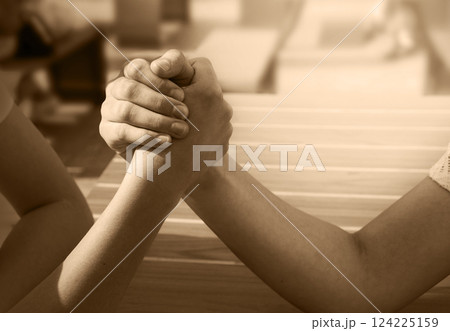 Hand wrestling contest of two girls Hand wrestling contest of two girls 124225159