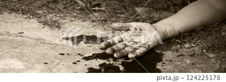 A man's hand in blood lies on the ground 124225178