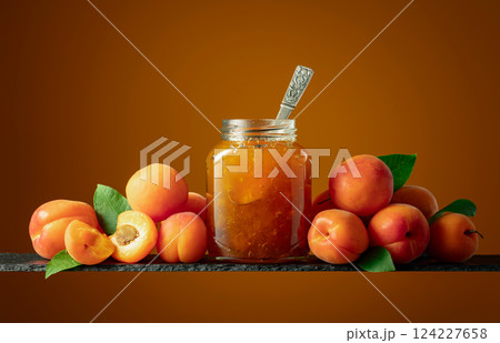 Apricot jam in glass jar and fresh fruits. 124227658