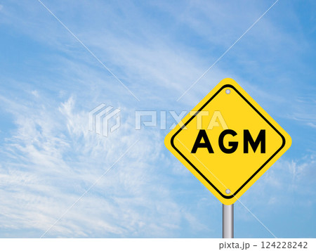 Yellow transportation sign with word AGM (Abbreviation of annual general meeting) on blue color sky background 124228242