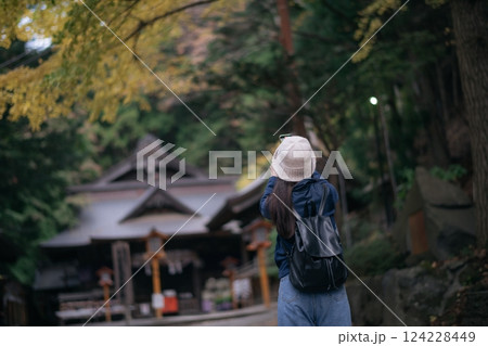 Asian woman discovers the spiritual essence of Japanese shrines and temples, radiating happiness, faith, and cultural appreciation in Tokyo and Kyoto. 124228449