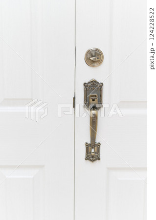 gold vintage style door knob in white door gold vintage style door knob in white door 124228522