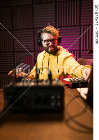 Sound engineer working at mixing panel in the boutique recording studio. 124228700