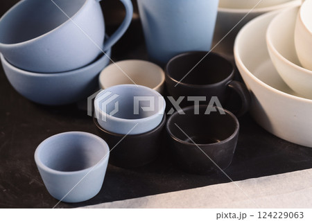 Matt ceramic handmade tableware in a workshop closeup 124229063