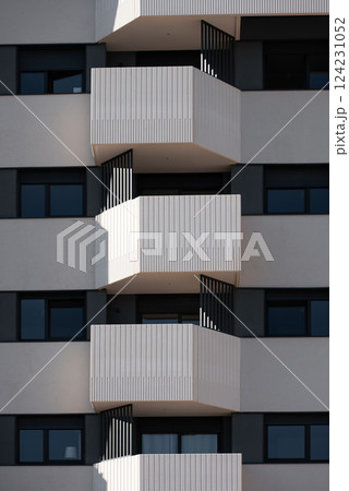 Contemporary building design with balconies and large windows on modern apartment complex in urban setting Contemporary building design with balconies and large windows on modern apartment complex in urban setting 124231052
