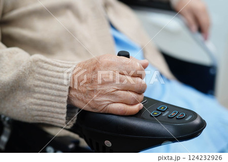 Asian elderly disability woman patient use joystick electric wheelchair in hospital. Asian elderly disability woman patient use joystick electric wheelchair in hospital. 124232926