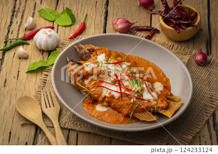 Fried Red Tilapia Fish with red curry sauce,Thai Choo Chee Fish Curry in a plate 124233124