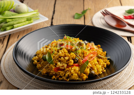 Southern Thai Yellow Curry Paste Fried Rice with ground pork in black plate.(khao pad Kuo Kling) 124233128