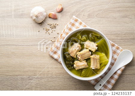 Pickled lettuce soup with pork spare ribs in white bowl.Top view Pickled lettuce soup with pork spare ribs in white bowl.Top view 124233137