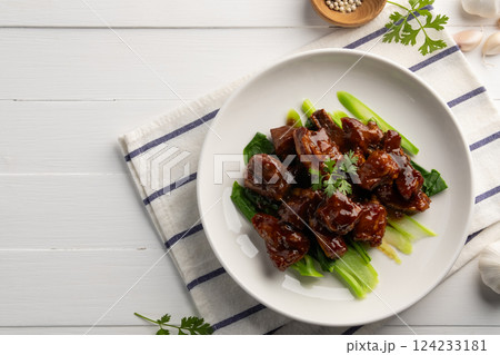 Honey Braised Pork Baby Back Ribs or pork cartilage with soy sauce in white plate.Top view copy space. 124233181