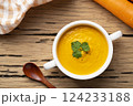 Bowl of tasty Creamy Carrot Soup with vegetables on wooden table,Healthy food.Top view 124233188