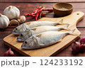 Raw fresh mackerel fish (short bodied mackerel ) on cutting board.Fresh seafood ingredients. 124233192