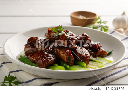 Close up Honey Braised Pork Baby Back Ribs or pork cartilage with soy sauce in white plate. 124233201