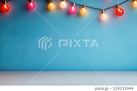 Bright string lights illuminate blue wall, creating cheerful atmosphere 124233944