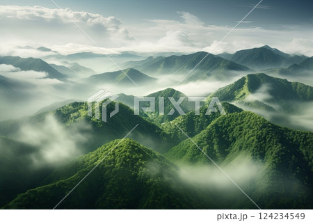 High mountains with green slopes in dense fog. Layers of mountains in the haze during sunset. Multilayered misty mountains. Krasnaya Polyana, Sochi, Russia. 124234549