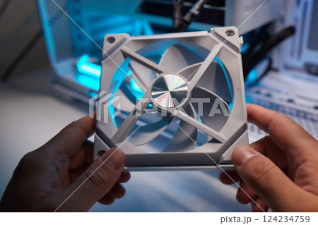 Computer technician installs cooling system of computer. 124234759