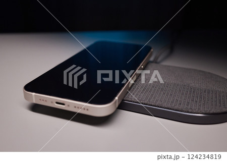 smartphone wireless charging on induction charger. Wireless charger smartphone wireless charging on induction charger. Wireless charger 124234819