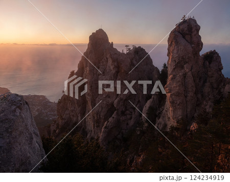 Golden hour photography on a foggy cliff. Solar wind. 124234919