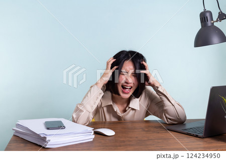 Tired, exhausted Asian woman with a laptop, problems with the project, feeling depressed, laziness in office Tired, exhausted Asian woman with a laptop, problems with the project, feeling depressed, laziness in office 124234950