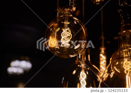 Decorative incandescent bulbs in Edison style on a brick wall background. Decorative incandescent bulbs in Edison style on a brick wall background. 124235133