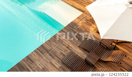 Turquoise swimming pool with wooden deck, lounge chairs, and umbrella in a modern outdoor setting 124235522