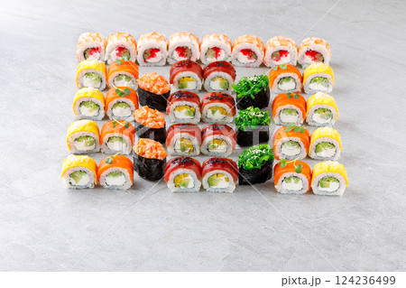 Japanese sushi rolls, sushi sets on a gray background for restaurant menu and food delivery Japanese sushi rolls, sushi sets on a gray background for restaurant menu and food delivery 124236499