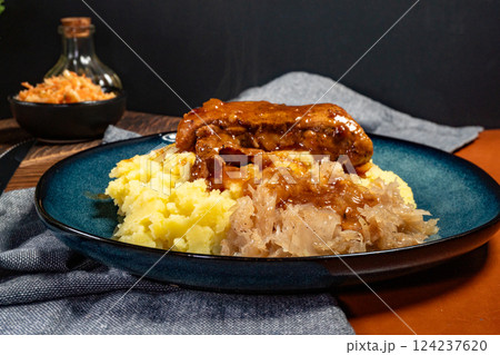Braised pork ribs with spicy sauce served with mashed potatoes and sauerkraut. Braised pork ribs with spicy sauce served with mashed potatoes and sauerkraut. 124237620