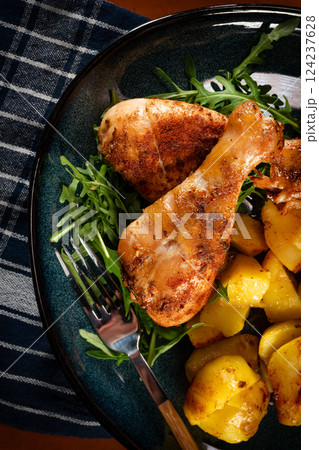Baked chicken drumsticks with potatoes. Baked chicken drumsticks with potatoes. 124237628