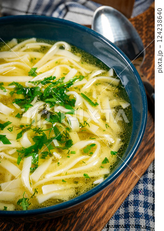 Broth - chicken soup in a bowl. 124238640