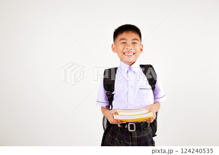 Portrait smile Asian little boy primary posing holding stack of books studio isolated white background, happy cute man kid wear school uniform and backpack learning and reading, back to school concept Portrait smile Asian little boy primary posing holding stack of books studio isolated white background, happy cute man kid wear school uniform and backpack learning and reading, back to school concept 124240535