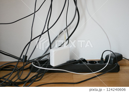 Lots of wires in a socket at work. Cabling chaos. Concept of the problem of saving space and aesthetics Lots of wires in a socket at work. Cabling chaos. Concept of the problem of saving space and aesthetics 124240606