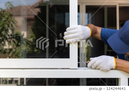 Worker replace aluminium sliding window lock. 124244641