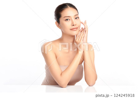 A beautiful young Asian woman with clean, fresh skin against a white background. Skincare, facial treatment, cosmetology, beauty, and spa. An elegant portrait of an Asian woman. 124245918