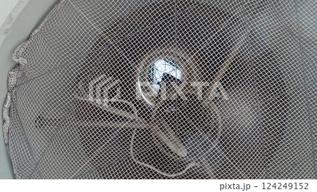 The interior of a tall control tower with the entrance protected by a mesh. 124249152