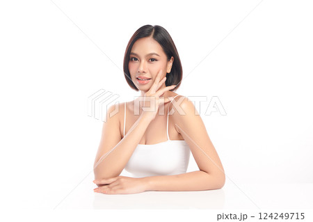 A beautiful young Asian woman with clean, fresh skin against a white background. Skincare, facial treatment, cosmetology, beauty, and spa. An elegant portrait of an Asian woman. 124249715