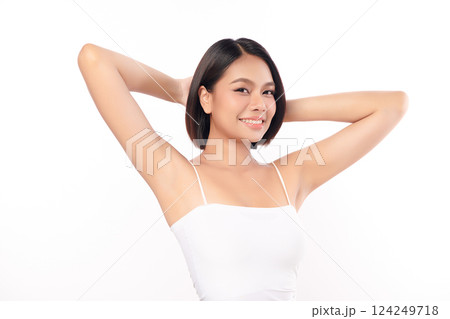 Beautiful Young Asian woman Raises her hands to Showcase clean and hygienic underarms Against a white background, Smooth armpit cleanliness and protection concept 124249718