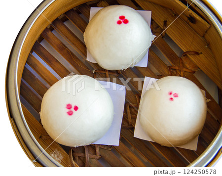 Top view of Three mini steamed pork bao in basket , focus selective Top view of Three mini steamed pork bao in basket , focus selective 124250578