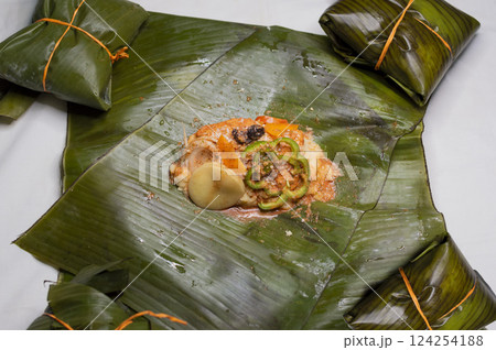 Top View of raw ingredients of the Nicaraguan nacatamal on banana leaves. Raw ingredients for the preparation of the traditional Nacatamal, Nacatamal ingredients on banana leaves 124254188