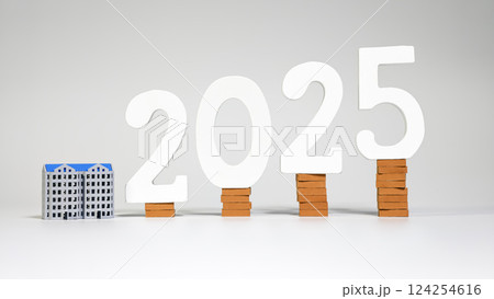 2025 real estate market forecast with house models and brick stacked 2025 real estate market forecast with house models and brick stacked 124254616