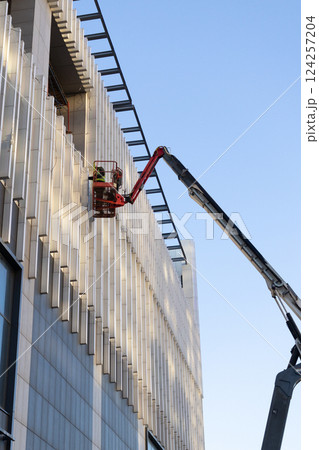 Construction crews and installers of high-rise buildings install fittings or lay electrical wiring 124257204
