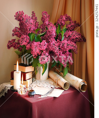 Still life from ancient book and lush boquet 124257441