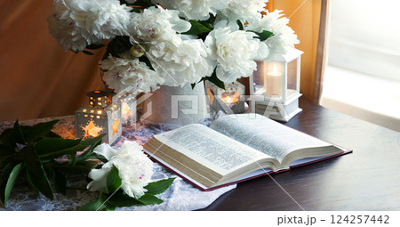 Still life. Open book and bouquet of flowers Still life. Open book and bouquet of flowers 124257442